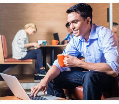 Young millennial laptop blogger in coffee lounge