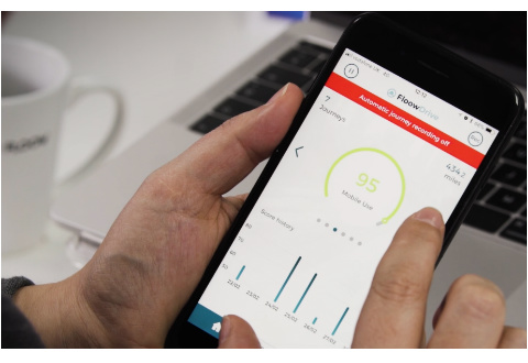 FloowDrive telematics software platform mobile app in hand